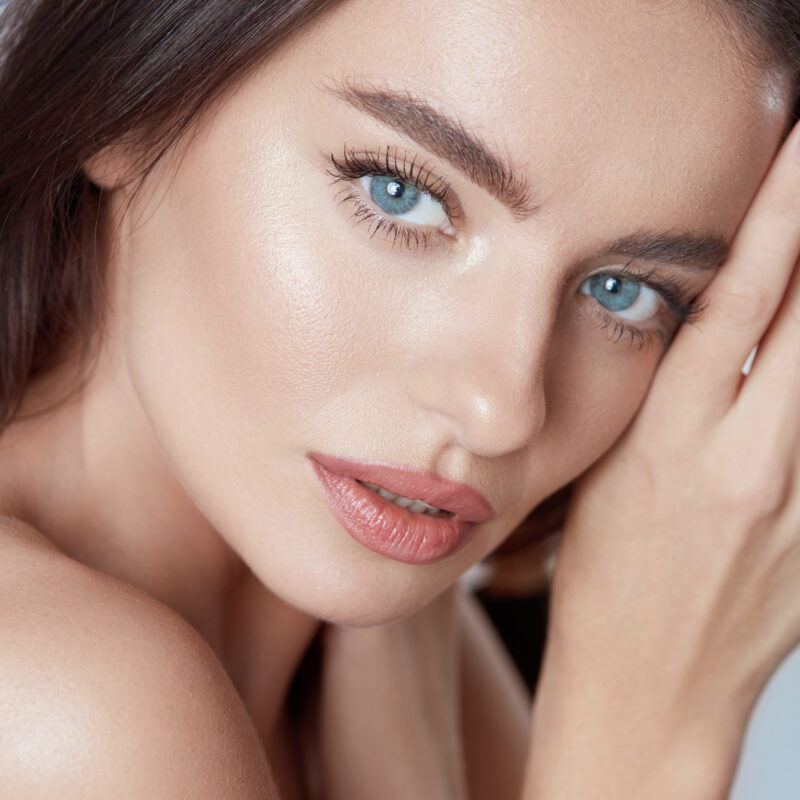 Beauty. Beautiful Woman Close Up Portrait. Young Blue-Eyed Model With Perfect Skin And Natural Makeup Looking At Camera.